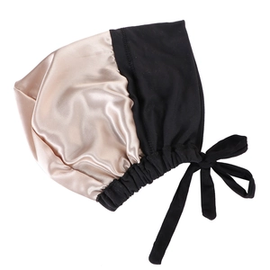 Close-up of dual-tone satin nightcap with adjustable ties and elastic band for hair care