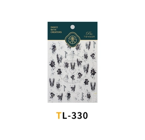 Detailed close-up of retro black butterfly and floral embossed nail stickers on paper card