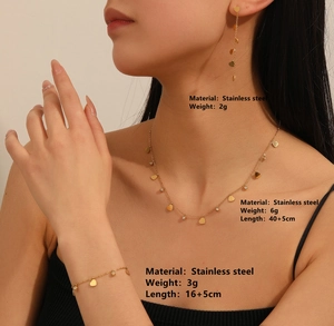 Detailed view of gold heart jewelry set worn by model showing sizes and dimensions
