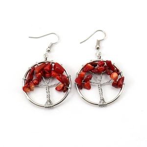 Detailed view of silver wire-wrapped Tree of Life earrings with red natural stone chips