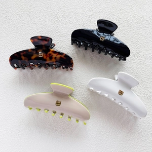 French style curved acetate hair claws in black, tortoiseshell and white with metal B letter