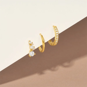 Detailed view of 3-piece gold S925 silver earring set with zirconia on display card