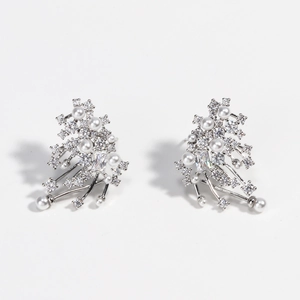 Detailed view of silver snowflake earrings with white pearls and sparkling crystals