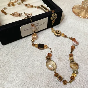 Vintage beaded necklace with ceramic heart, crystal beads, and butterfly flower charms