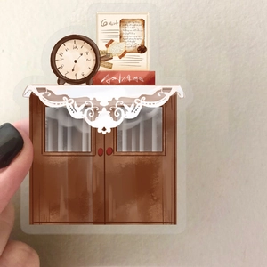 Detailed view of vintage cafe style wooden cabinet sticker with retro clock and books