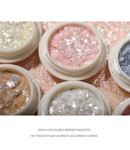 Close-up of Aurora Opal nail glitter powder and sequins in round jars for nail art