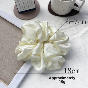 Detail of 18cm cream satin oversized scrunchie showing measurements and soft texture