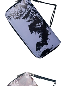 Detail view of long skull and bat leather wallets with zippers and wristlet straps