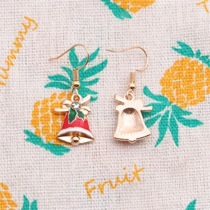 Detail of Christmas bell earrings with red enamel finish and sparkling rhinestone accent