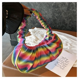 Close-up of vibrant rainbow gradient pleated shoulder bag with silky textured handle