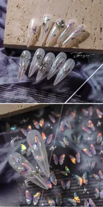 Detailed macro view of 5D holographic butterfly nail stickers with pearls and rhinestones
