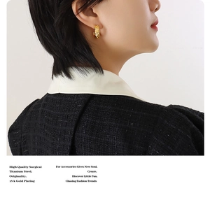 Close-up of forged C-shape gold earrings on model highlighting 18K gold plated titanium steel