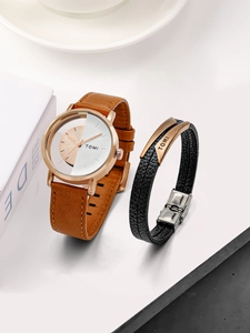 Close-up of rose gold watch and black woven leather bracelet with stainless steel accents