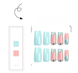 Detail of pink and blue gradient coffin press-on nails with rhinestones and glitter