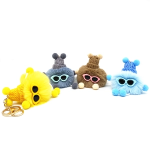 Cute plush soot sprite keychains with sunglasses and knit hats on white background