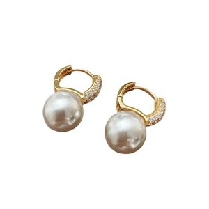 Elegant gold pearl hoop earrings with zircon stones and white pearls on white background