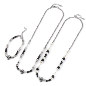 Gothic beaded jewelry set with silver skull charms, pearls, and black beaded chains