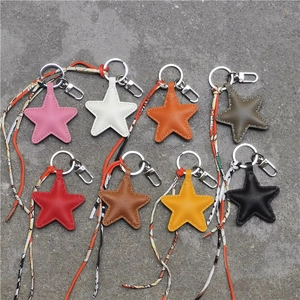 Star shaped handmade leather keychains with colorful ribbons and metal clasps in eight colors