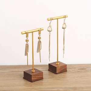 Elegant walnut wood and gold metal jewelry stand set for earrings on white background