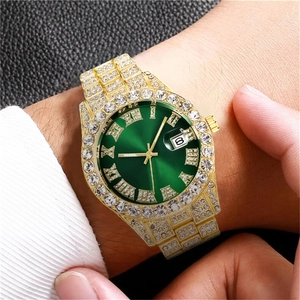 Detail of luxury men's gold watch with green sunburst dial and full diamond setting