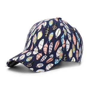 Detailed view of dark blue baseball cap featuring colorful bohemian feather prints