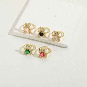 Detailed shot of five gold teddy bear rings with heart zircons in assorted colors