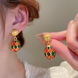 Vintage gold oval earrings with colorful diamond pattern enamel and harlequin design