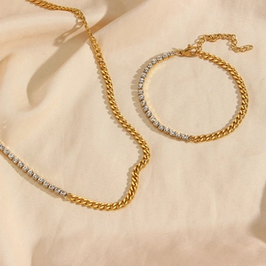 Detail of gold-plated Cuban link chain necklace and bracelet set with sparkling zircon stones
