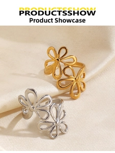 Detail of gold and silver flower open rings with hollow petal design on silk fabric