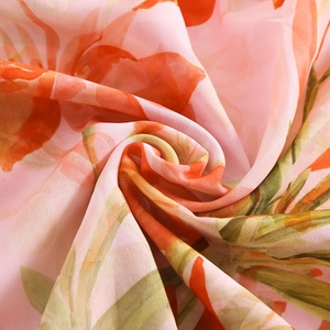 Close-up of lightweight chiffon fabric with pink and orange floral prints