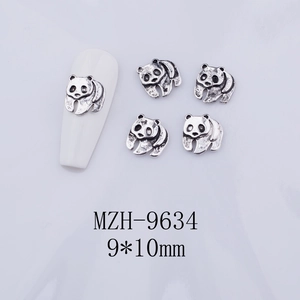 Detail of 3D panda nail charms in vintage silver metal with embossed relief texture