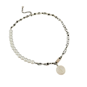 Minimalist pearl necklace with silver chain and Saint Benedict pendant on white background