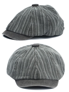 Detail view of grey striped newsboy cap with top button and classic curved brim style