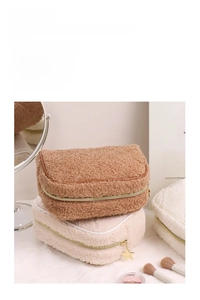 Detailed close-up of teddy fleece makeup bags with quilted texture and star charms