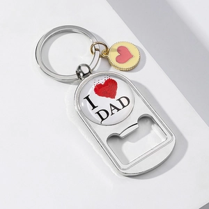 Macro detail of silver metal bottle opener keychain with I Love Dad heart glass dome