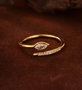 Close-up of gold-plated snake ring featuring marquise-cut and pavé-set zircons