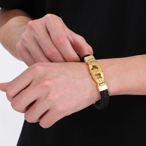 Punk woven leather bracelet with gold stainless steel links on a model wrist