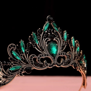 Detail of baroque crown with emerald green crystals and vintage bronze filigree