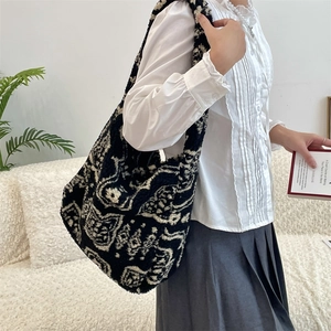 Macro shot of large plush shoulder bag with black and white retro paisley pattern