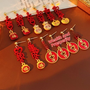 Detail of red and gold Chinese New Year earrings with vintage enamel tassel charms