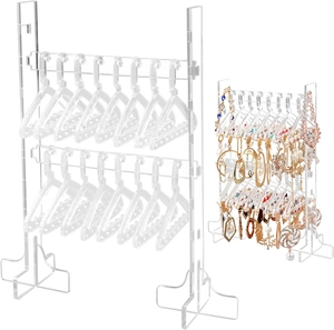 Detailed set of clear acrylic earring organizers with mini clothes hanger hooks on white base
