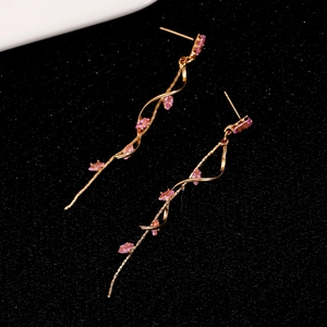 Detailed view of rose gold wave tassel earrings with pink marquise-cut zircons