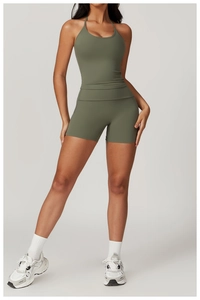 Olive green yoga set featuring a halter neck sports bra and high-waisted fitness shorts
