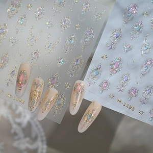 Golden lace bow nail stickers M-1198 with gemstone designs on nude nails