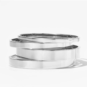Minimalist stackable silver stainless steel bangles set with four varied widths on white