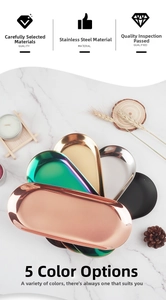 Detailed view of oval stainless steel trays in five metallic colors on marble