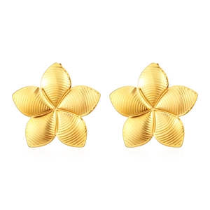 Macro shot of gold floral earrings featuring textured petals and polished metallic finish