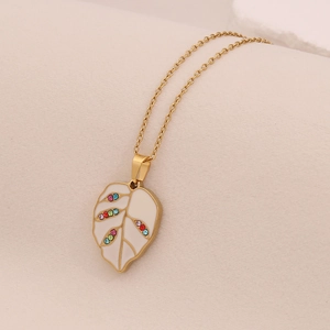 Detailed view of leaf pendant with colorful rhinestones on a gold stainless steel chain