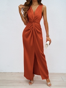 Detail of elegant rust red satin dress featuring waist twist and high side slit