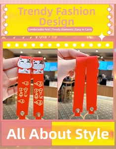 Detail of red silicone Maneki Neko lanyard with golden buckle and blessing text